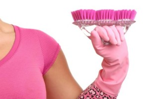 Woman holding cleaning supplies to represent Grace Bubble Cleaning