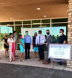 A group of people in front of Laveen Lasik for its grand opening and ribbon cutting in Laveen Village.