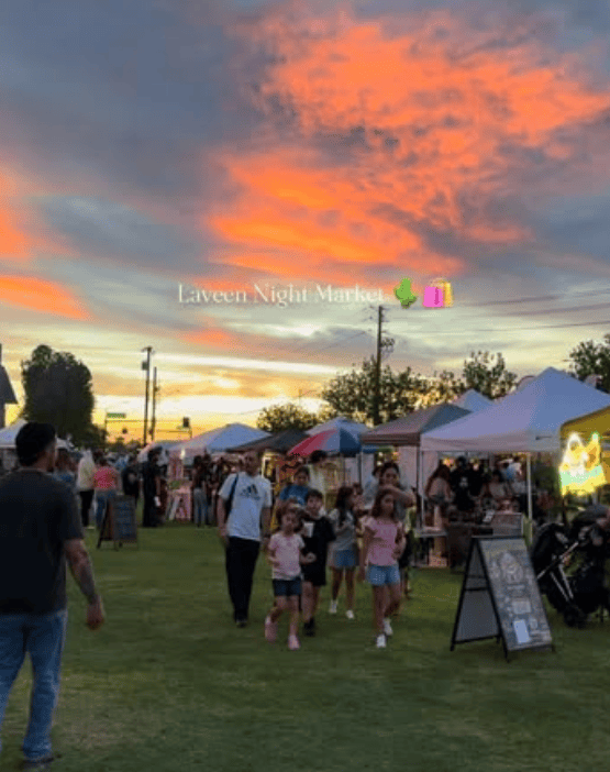 Sunset at the Laveen Night Market, with community vendors and visitors gathered outdoors in Laveen, Arizona.