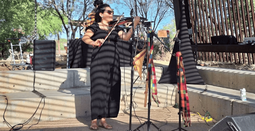 Violinist performing outdoors during a community music event